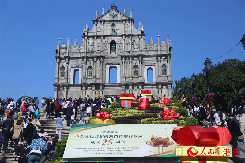 大三巴牌坊前立起慶祝澳門回歸祖國25周年的招牌。（人民網(wǎng) 吳宇揚揚 攝）