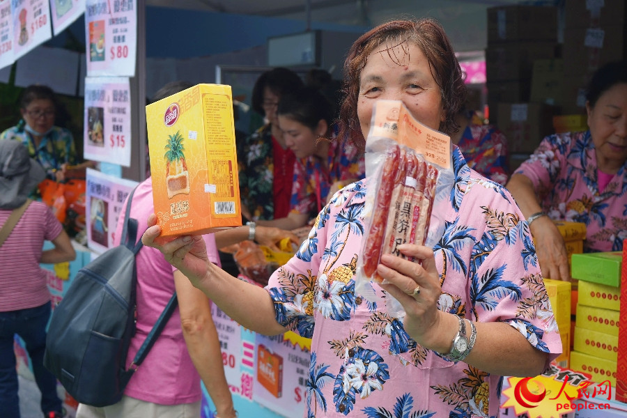商戶熱情展示特色食品。人民網(wǎng) 實(shí)習(xí)生王悅 攝