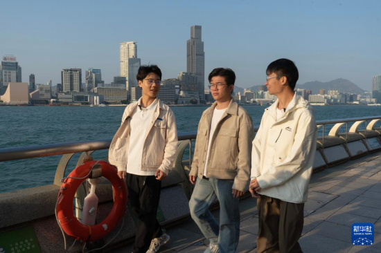   2月17日，在香港灣仔海濱長廊拍攝的何金淼（中）、溫建彬（右）和王皓霖。新華社發(fā)（龍鏡伊攝）