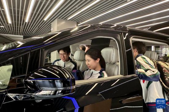 澳門坊眾學(xué)校學(xué)生在廣州體驗(yàn)一款電動(dòng)汽車（3月21日攝）。新華社記者 郭雨祺 攝